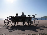 SX08990 Jenni and Marijn sitting on bench with push bikes at Penzance promenade.jpg